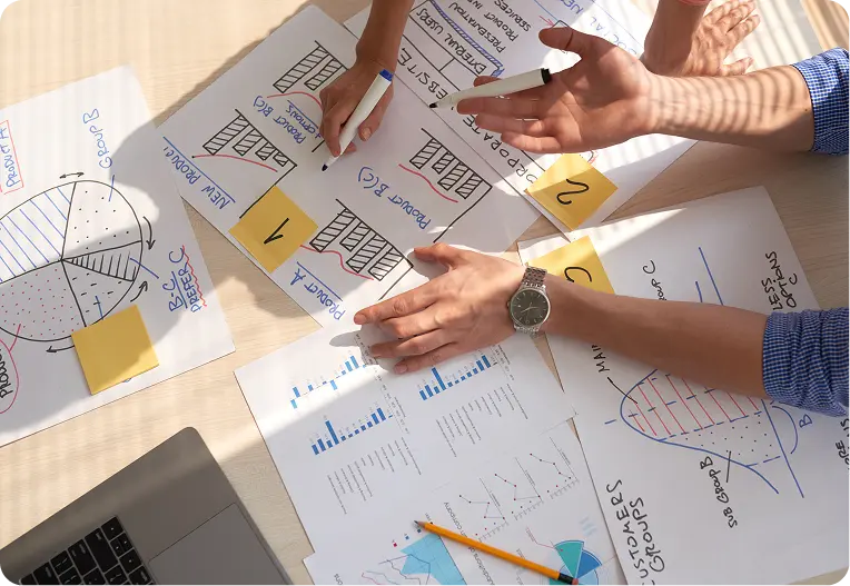 AI & IT Consultation 17 top view creative team discussing business graphs drawn marker pens 1